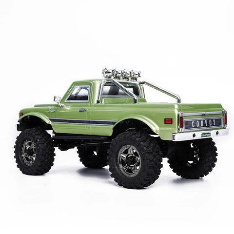 Badass 1/18 Scale RC Crawler With Slick Shifting Two Speed Transmission And Bulletproof Metal Gears Nasty Terrain Rock Climbing Rig Trail Smashin Setup Drop In Ready Convoy Medium Olive Green rear view showcasing rugged tires and chrome accents.