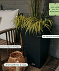 Indoor Outdoor Taper Planter Set Of 2 Dope 30 Inch Black Plastic Resin Planters beside a chair with decorative grass.