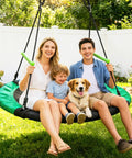 Family enjoying Spacious 48 Inch Saucer Swing For Backyards And Trees The Ultimate Backyard Hangout For All Ages in garden.