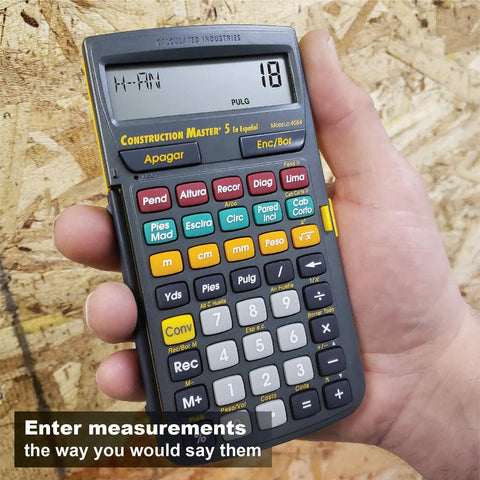Spanish Display Construction Master 5 Foot Inch Fraction Calculator for Carpenters held in hand on plywood background