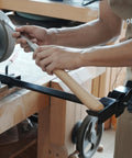 BG-GRIND4 4-piece woodworking sharpening jig in use, clamped to a bench grinder while sharpening a chisel.