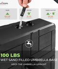 Beefy 100 Lb Fillable Umbrella Base With 4 Wheels And Dual Locks for Easy Move Rust Resistant And Windproof Stand in black being filled with water.