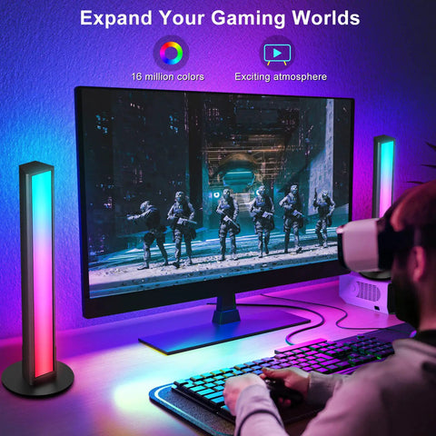 Lit RGB LED Smart Light Bars for TV and PC backlighting setup next to a gaming monitor showing soldiers on screen.