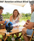 Group of people playing cards outdoors with Magnetic Golf Cart Fan With Mist And Light 12000mAh Power Bank on table.