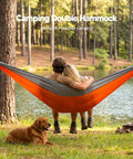 Ultralight Camping Hammock For Hiking And Travel, Durable Outdoor Hammock In Orange, two people relaxing by a lake