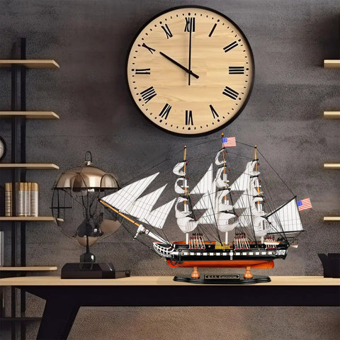 Wooden USS Constitution Model Ship 1/95 Scale Frigate Replica For Home Decor on desk under large clock