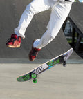 Skateboarder performing trick with Minecraft Mob 31 Inch Skateboard With 9-Ply Maple Deck for cruising and carving in skatepark