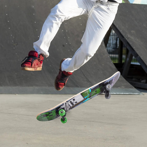 Skateboarder performing trick with Minecraft Mob 31 Inch Skateboard With 9-Ply Maple Deck for cruising and carving in skatepark
