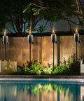 Stainless Steel Outdoor Torches Set Of 2 5 Ft Citronella Oil Lamps with Fiberglass Wick and Snuffer Cap around poolside