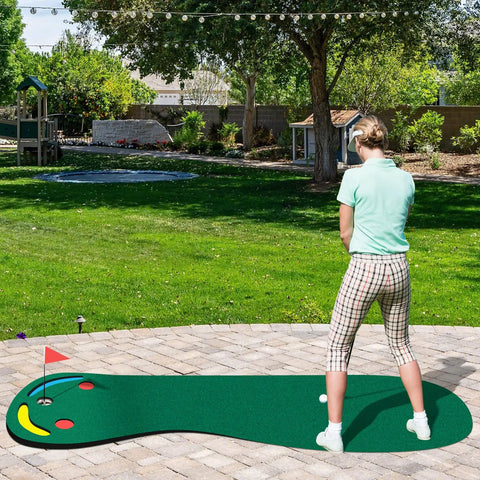 Person practicing golf on a Par 3 Putting Green Mat 10 Foot By 3 Foot With 3 Cups Flag And Hole Covers for outdoor use