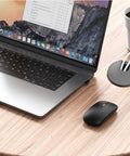 Laptop setup with Black Desk Cable Grommets 1.5 Inch Plastic Hole Covers for organizing cables, showing tidy desk environment.