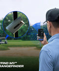 Golfer using Captain Air Golf Rangefinder With Slope And GPS Distances app, focusing on rangefinder and golf course in the background.