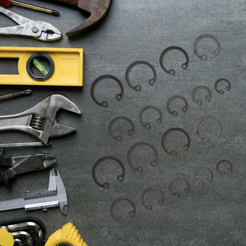 Assorted tools next to External Circlip Assortment Kit 100 Pcs Black Steel C Clips for DIY auto repairs.