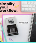 Straight Up Knockout Date Stamp For Shipping And Receiving Orders Track Expiration And Due Dates Smooth Gliding Mechanism Crisp Black Ink On Durable Gray Mount on a desk with stationery.
