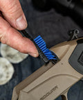 Using Caliber 50 Muzzleloader Cleaning Kit With Caliber Specific Bronze Bore Brush Pierce Point Jag Slotted Tip 100 Percent Cotton Patches Nylon All Purpose Cleaning Brush Straight Pick And Hand Tool Go To Gear For Your Muzzleloader Maintenance, a hand holds a blue nylon brush cleaning a muzzleloader breech.