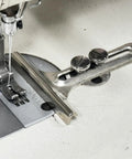 2.5 Inch Wide Seam Guide With Dual Thumb Screws For Precision Stitching On Sewing Machines shown attached to a machine