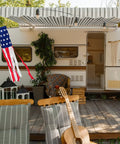 Patriotic Windsock 40 Inch With Embroidered Stars hanging on a porch beside a trailer, showcasing American flag theme outdoor decor.