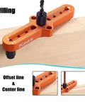 Kaas self-centering dowel jig in orange with ruler scale and center finder knob mounted on wood