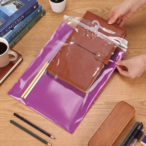 Hands using 30 Piece Hanging Book Storage Bags With Hooks Clear Book Buddies For Students And Teachers Colorful Set Of 5 Colors Red Yellow Blue Green Purple Classroom Organizer And Back To School Gift Must Have Classroom Supply to store a notebook.