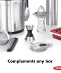 Stainless Steel Two Sided Jigger With Flip Measurements on a bar counter with other kitchen tools