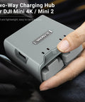 Compact Two Way Battery Charger Hub For DJI Mini 4K And DJI Mini 2 Drones being held, showing dual USB ports.