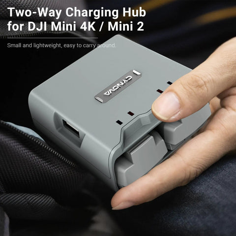 Compact Two Way Battery Charger Hub For DJI Mini 4K And DJI Mini 2 Drones being held, showing dual USB ports.