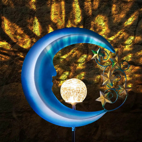 Solar Powered Outdoor Lights Moon And Star Garden Stake Decor with glowing orb against a textured wall backdrop.