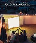 Patio scene with friends, 100 Ft Outdoor String Lights With 102 G40 Bulbs Warm White 2200K Incandescent, cozy atmosphere.
