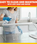 Person cleaning tempered glass sneeze guard for Hot Dog Roller Cover With Tempered Glass Sneeze Guard For Nine Roller Hot Dog Machine On Countertop Electric Grill Shield To Keep Food Fresh Safe And Ready To Serve
