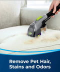 Person using 2-In-1 Pet Upholstery Tool For Carpet And Upholstery Cleaners Tackle Pet Hair, Stains, And Odors on a stained couch