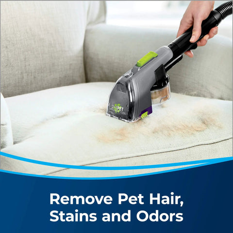 Person using 2-In-1 Pet Upholstery Tool For Carpet And Upholstery Cleaners Tackle Pet Hair, Stains, And Odors on a stained couch