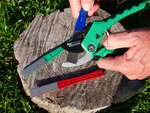 Using DiaSharp Diamond Mini Hone Sharpening Kit With Coarse Fine And Extra Fine Grit Stones for garden tool edge restoration on a log.