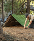 Tough As Nails Heavy Duty Survival Blanket With Reflective Thermal Layer For Camping And Outdoor Gear Waterproof Tarp Or Shelter 8.5 Ft By 12 Ft Olive Green All Weather Ready set up in forest