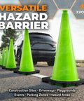 28 Inch Lime Green Traffic Cone 6 Pack Heavy Duty PVC Safety Cone For Parking Lots Construction Zones Road Crews And Emergency Vehicles DOT Approved in line on asphalt with a backdrop of a car in the distance.