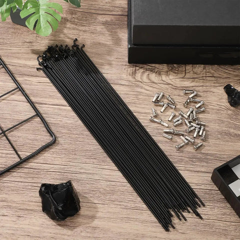 36Pcs 14G Bicycle Spokes Kit 2mm Diameter 260mm Length for 26 Inch Rims with Caps on wooden surface