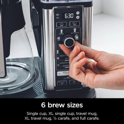 Hand adjusting settings on Specialty Coffee Maker For Hot And Iced Brews With Four Styles Classic Rich Over Ice And Specialty Brew Eight Size Options From Small Cup To Travel Mug Ten Cup Carafe Fold Away Frother Permanent Filter Removable Reservoir Black
