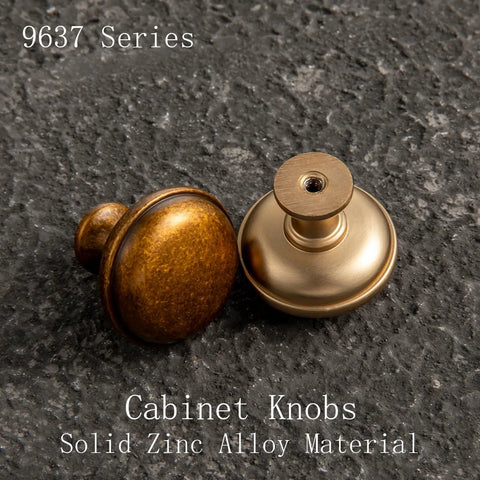 Antique Brass Cabinet Knobs 6 Pack Set, Zinc Alloy Drawer Pulls For Kitchen Cabinets, two knobs on textured surface