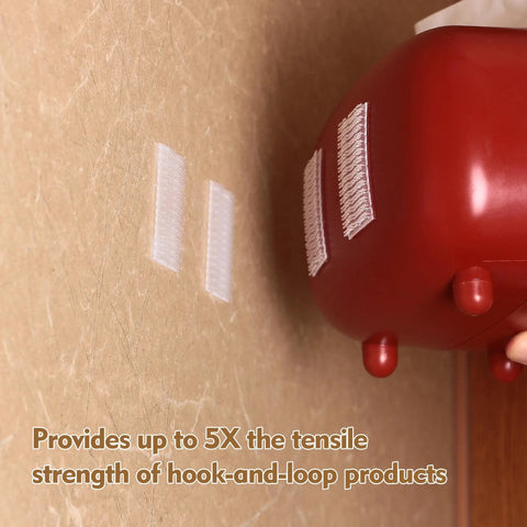 Premium Recloseable Fastener Tape Strips One By Two Inch Clear Heavy Duty Adhesive Pad Ten Pack on a wall holding a red object.