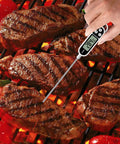Using Digital Meat Thermometer For Cookin And BBQ With Long Probe to check steak temperature on grill with bright LCD display
