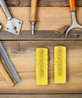 Forty Heavy Duty Paint Texture Sponge Rollers For Nailing Perfect Embossed Wall Finishes On Gnarly Surfaces With An Elastic Grip That Makes Rolling Breezy For Total Game Changing Home Improvement Upgrades displayed on a wooden workbench with tools.