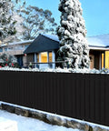 Black 3x16 Balcony Privacy Screen Made From HDPE UV Protected Fence Mesh Shade Net Cover in snowy garden setting