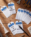 Out Of Service Notice Tags Kit With 30 White 5.5 by 3 Inch Signs in 32 Mil Vinyl Material and 30 Heavy Duty Cable Ties on wooden table