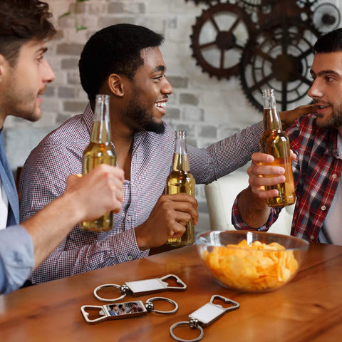 Men enjoying drinks around table with 20 Pack Sublimation Keychain Blanks With Bottle Opener Dope Aluminum Rectangle Metal Key Rings