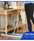 Top Shelf 24 Inch Cotton Dust Mop Kit With Heavy Duty Aluminum Handle being used for easy sweeping under furniture.