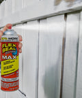 Hand spraying Flex Seal Max on wooden fence for waterproof coating, 17 oz can in use
