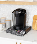 Space Saving 36 Pod Coffee Pod Drawer Black Metal Mesh Under Cabinet Organizer with coffee maker on marble counter