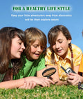 Children using Outdoor Adventure Kit For Kids With Real Walkie Talkies, Binoculars, Flashlight, Compass, Magnifier, Whistle, Camouflage Hat And Backpack For Backyard Missions, Park Explorations, And Indoor Quests in a grass field.