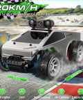 Silver all terrain RC car with 720P HD FPV camera and LED lights for real-time video, rechargeable, 1 to 28 scale, on track.
