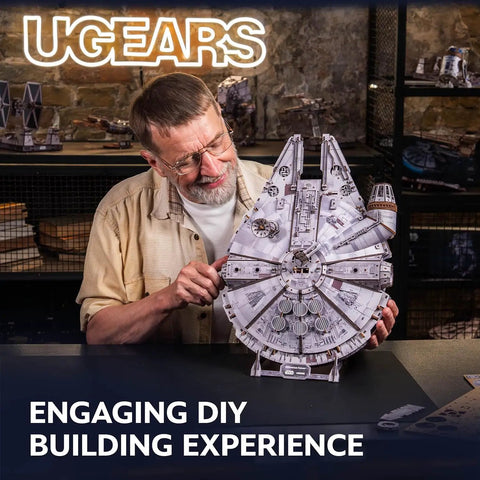 Millennium Falcon 3D Wooden Puzzle Kit With Lit LED Hyperdrive Glow DIY Mechanical Model 3D Brain Teaser For Adults Realistic Interior And Exterior Boarding Ramp And Cargo Bay Rotating Turrets 360 Degree Radar Antenna Wood Model Building, man holding assembled wood model