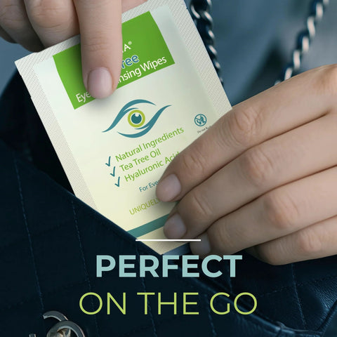 Front view of a NOVEHA eyelid and lash wipe sachet with green label being pulled from a handbag for eye cleansing.